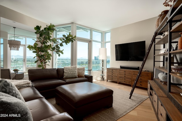 living room with floor to ceiling windows and light wood-type flooring