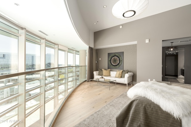 bedroom with hardwood / wood-style flooring and expansive windows