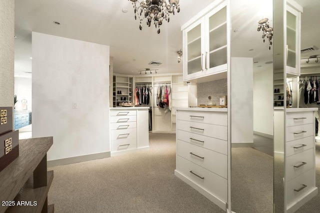 walk in closet featuring light carpet