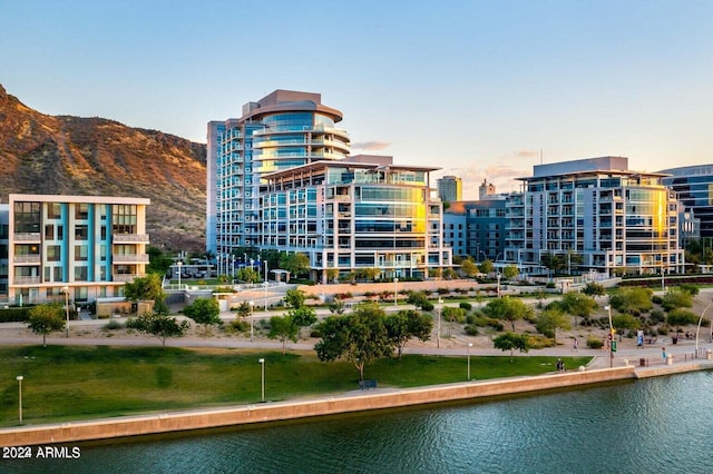 outdoor building at dusk featuring a water and mountain view