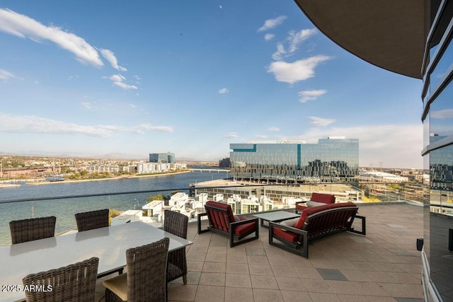 view of patio featuring a balcony and a water view