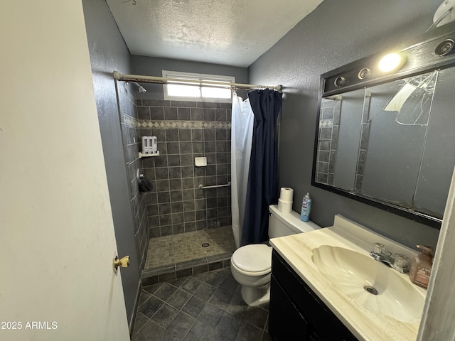 full bath with a textured ceiling, toilet, a tile shower, tile patterned floors, and vanity