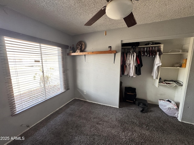 unfurnished bedroom with a closet, a textured ceiling, carpet, and ceiling fan