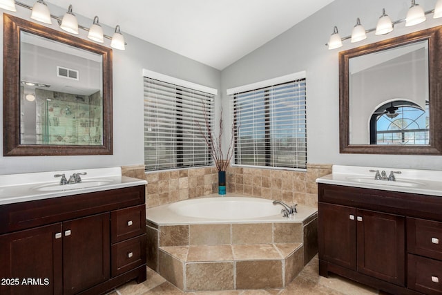 full bath with two vanities, lofted ceiling, visible vents, and a sink