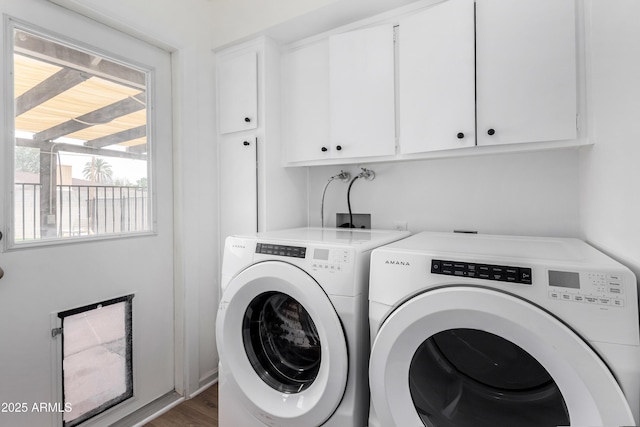 laundry area with cabinet space, dark wood-style floors, and washer and clothes dryer