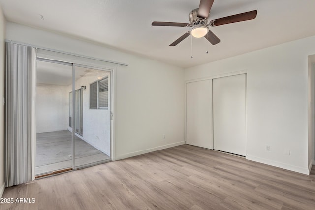 unfurnished bedroom featuring ceiling fan, access to exterior, a closet, and light wood-type flooring