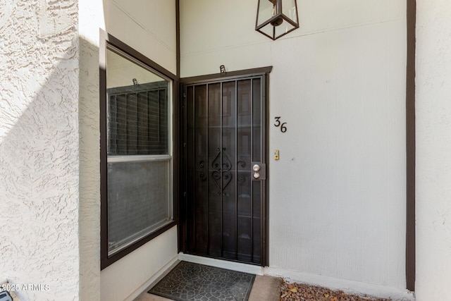 doorway to property featuring stucco siding