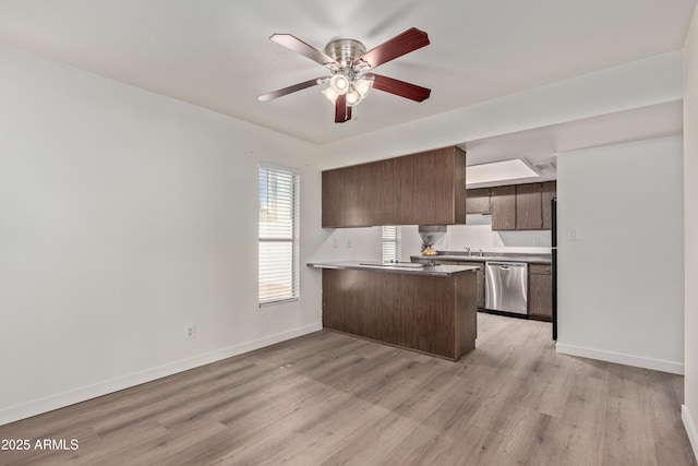 kitchen with dishwasher, sink, kitchen peninsula, and light hardwood / wood-style flooring