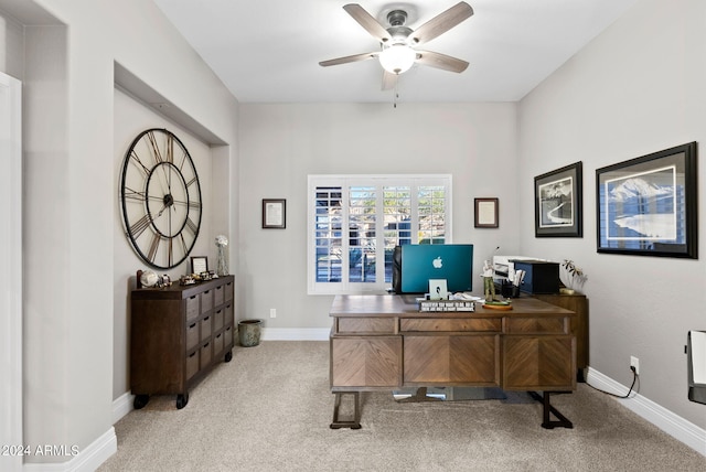 carpeted office space with ceiling fan