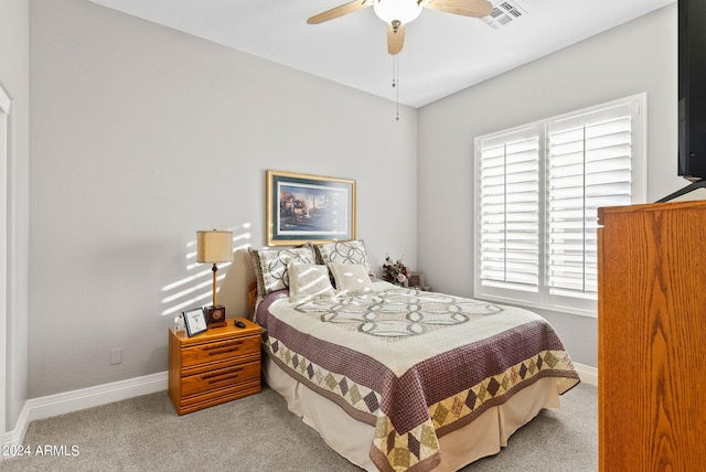 bedroom featuring ceiling fan and light carpet