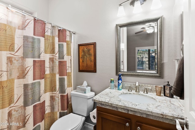 bathroom featuring ceiling fan, toilet, and vanity