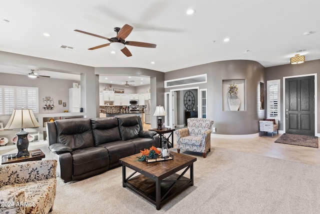 living room with light colored carpet and ceiling fan