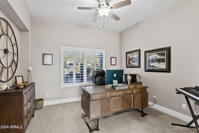 carpeted office space featuring ceiling fan