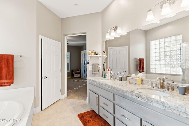 bathroom featuring tile patterned flooring, vanity, and a bathtub