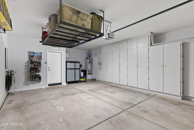 garage featuring gas water heater and a garage door opener