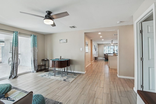 interior space featuring visible vents, baseboards, ceiling fan, recessed lighting, and light wood-style floors