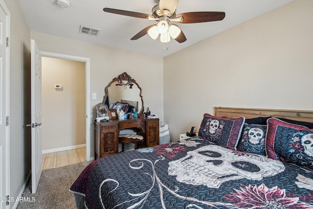 bedroom with baseboards, ceiling fan, and visible vents