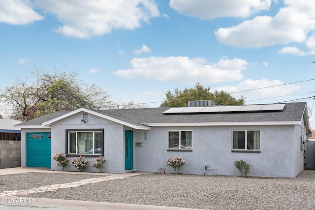 ranch-style house featuring stucco siding, driveway, a garage, and roof with shingles