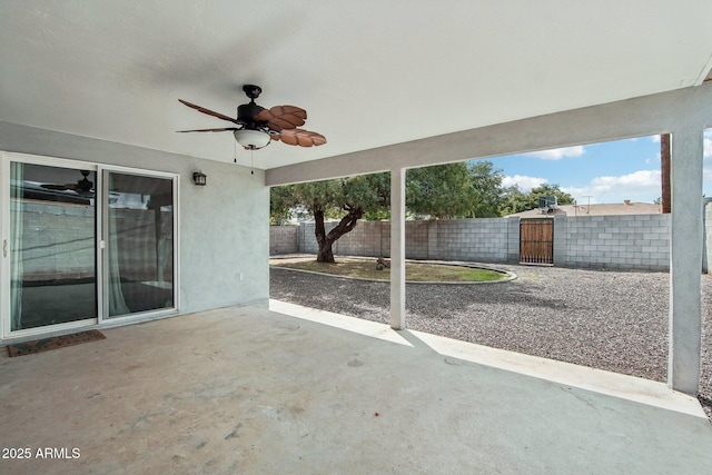 view of patio / terrace with a gate, fence, and ceiling fan