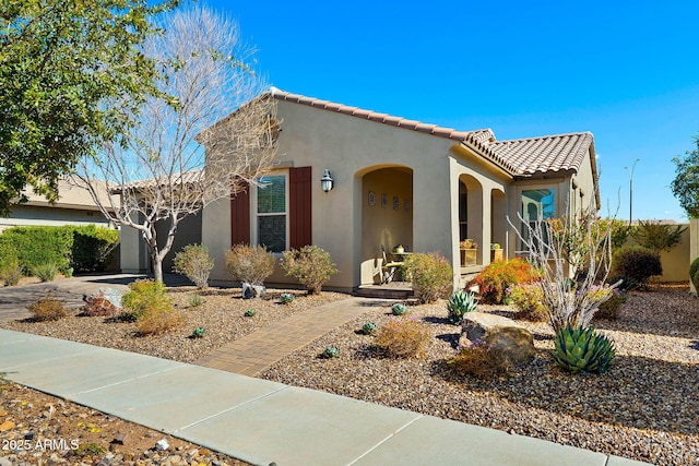 mediterranean / spanish-style house featuring a tile roof and stucco siding