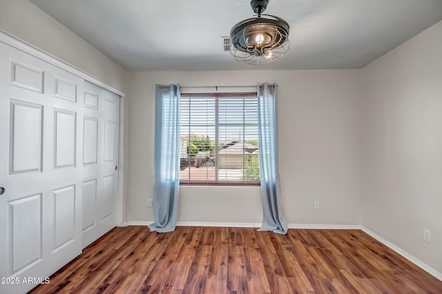 11936 W Alvarado Rd, Avondale, AZ 85392 - unfurnished bedroom featuring a chandelier, wood finished floors, and a closet