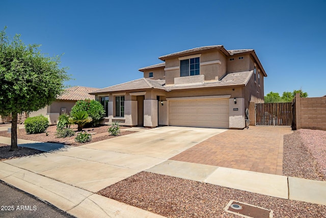11936 W Alvarado Rd, Avondale, AZ 85392 - view of front of home with stucco siding, concrete driveway, a gate, an attached garage, and a tile roof