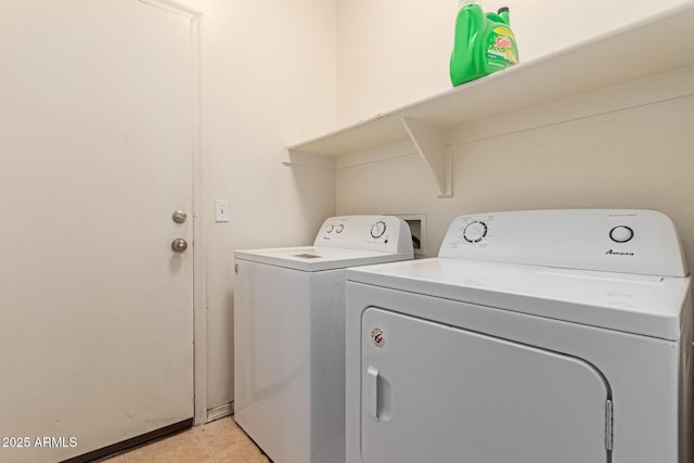 laundry room featuring laundry area, light tile patterned flooring, and independent washer and dryer