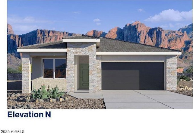 view of front facade featuring a garage and a mountain view