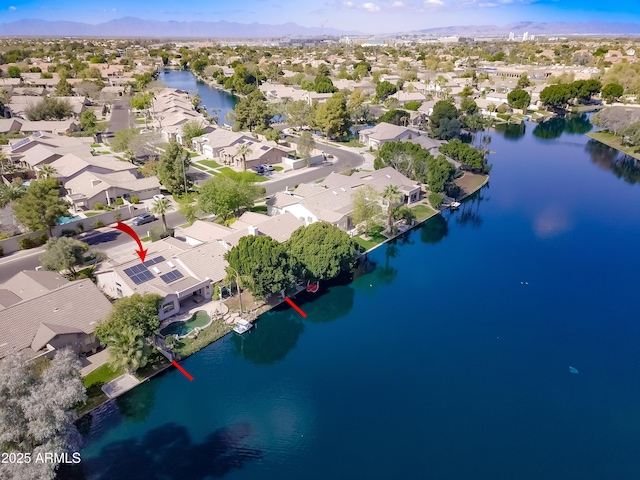 birds eye view of property with a water view and a residential view