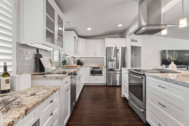 kitchen with white cabinetry, appliances with stainless steel finishes, island range hood, and decorative light fixtures