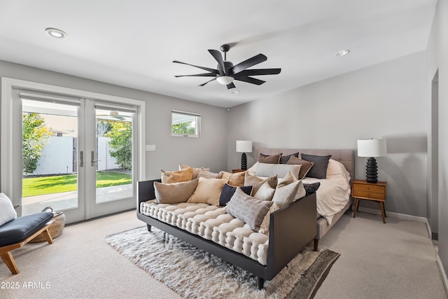 bedroom with light carpet, access to exterior, french doors, and ceiling fan