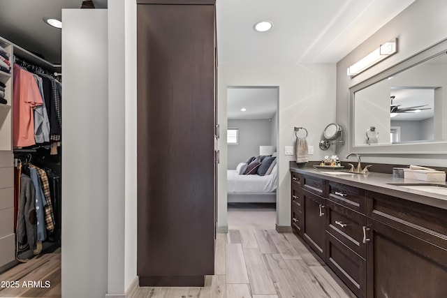 bathroom with vanity, hardwood / wood-style flooring, and ceiling fan