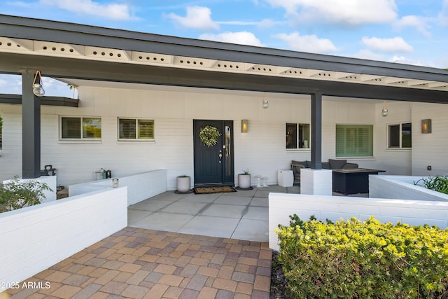 view of front facade with outdoor lounge area and a patio