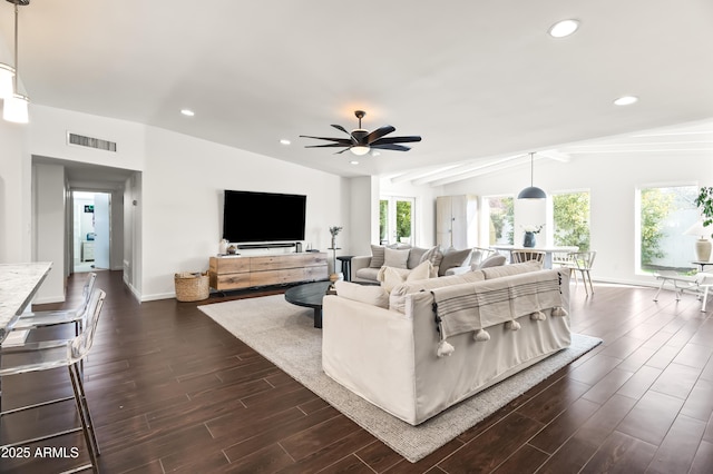 living room with dark wood-type flooring, ceiling fan, and lofted ceiling