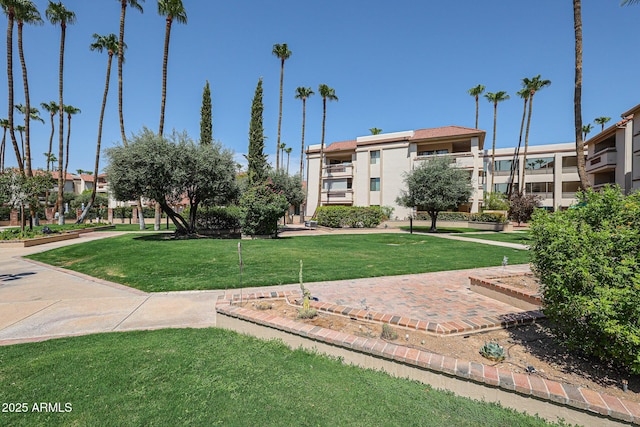view of property's community with a lawn