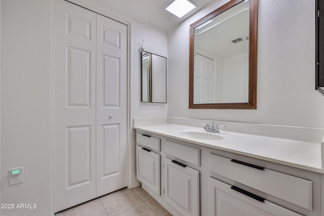 bathroom featuring tile patterned floors, visible vents, and vanity