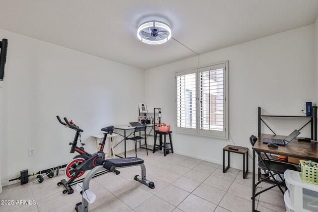 exercise room featuring baseboards and tile patterned flooring