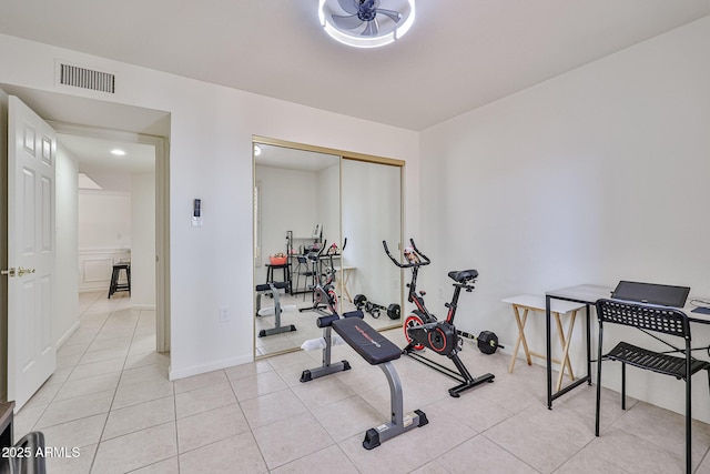 workout area featuring light tile patterned floors, baseboards, and visible vents