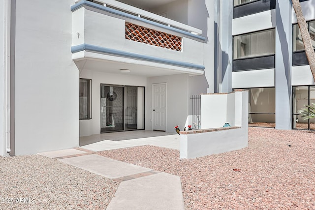 property entrance with stucco siding