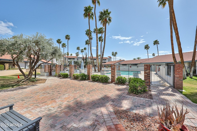 view of community featuring a gate, fence, and a pool
