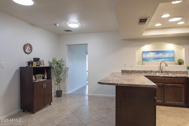 2925 E Dragoon Ave, Mesa, AZ 85204 - kitchen featuring a peninsula, light tile patterned floors, dark brown cabinetry, and recessed lighting
