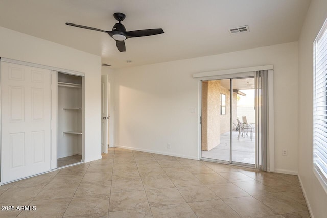 2925 E Dragoon Ave, Mesa, AZ 85204 - unfurnished bedroom featuring access to outside, multiple windows, light tile patterned floors, and a ceiling fan