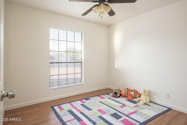2925 E Dragoon Ave, Mesa, AZ 85204 - unfurnished bedroom with multiple windows, wood finished floors, and a ceiling fan