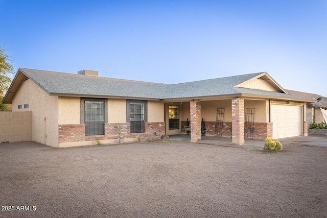 2925 E Dragoon Ave, Mesa, AZ 85204 - view of front of home featuring brick siding, a garage, a shingled roof, and driveway