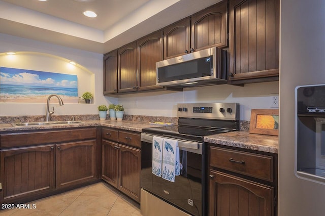 2925 E Dragoon Ave, Mesa, AZ 85204 - kitchen featuring appliances with stainless steel finishes, light tile patterned flooring, dark brown cabinetry, and recessed lighting