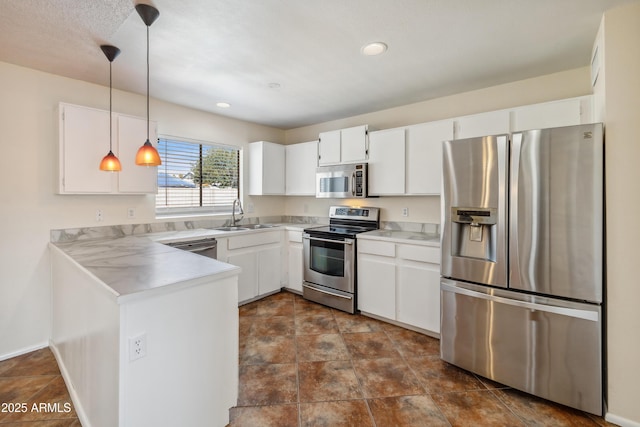 kitchen featuring white cabinets, stainless steel appliances, and a sink