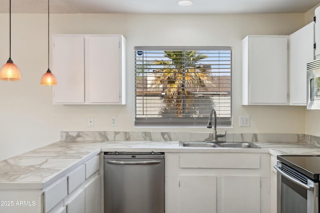 kitchen featuring white cabinetry, stainless steel appliances, light countertops, and a sink