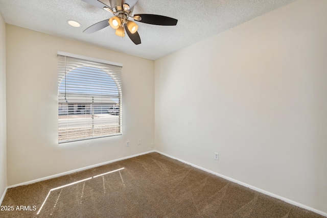 empty room featuring ceiling fan, carpet flooring, baseboards, and a textured ceiling