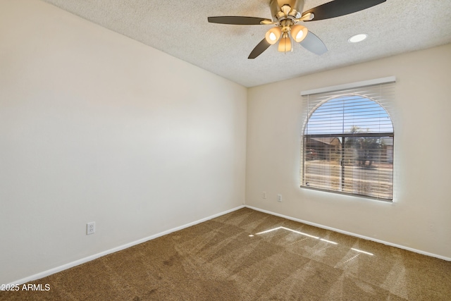 unfurnished room featuring baseboards, a textured ceiling, ceiling fan, and carpet flooring