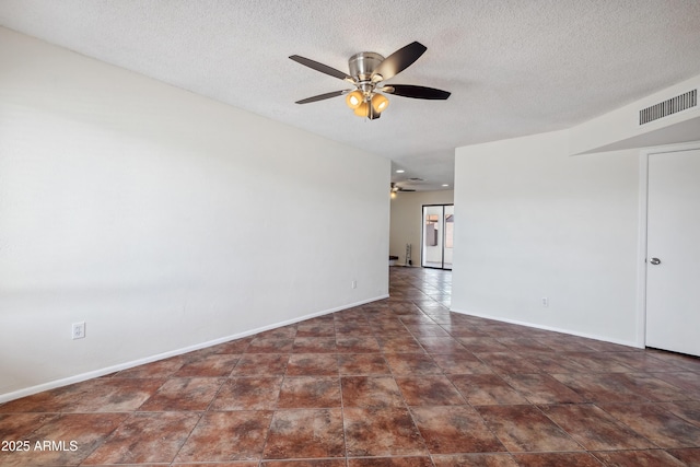 spare room with baseboards, visible vents, a textured ceiling, and a ceiling fan